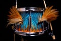 drumsticks resting on snare drum with custom logo