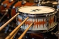 drumsticks resting on snare drum with custom logo