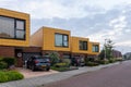 Drunen, The Netherlands - august 17, 2021: Yellow tiled houses architecture with a lower red-brown brick style