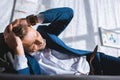 drunk businessman having headache while lying