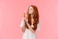 Drunk and carefree sassy good-looking redhead woman feeling amused and happy, kissing glass with champagne as got wasted Royalty Free Stock Photo