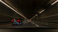 Drunk and drive scene: Blurry view from the inside of a car through the front window with other cars in a tunnel -