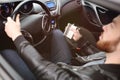 Young man driving a car with an iron flask Royalty Free Stock Photo