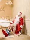 Drunk Father Christmas sitting on the toilet Royalty Free Stock Photo