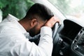 Drunk indian man slumped on steering wheel in his car