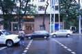 Drunk man crossing road in the rain