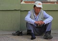 Drunk man is sitting on asphalt in Ulaanbaatar