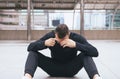 Drunk man sitting on street after drinking alcohol in party at night