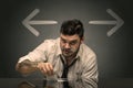 Drunk man sitting at table with arrows around Royalty Free Stock Photo