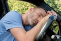 drunk man slumped over steering-wheel