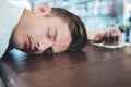 Drunken man sleeping on a bar counter Royalty Free Stock Photo