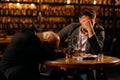 drunken men sleeping on a table in a pub after work. friends, colleagues, drink alcohol Royalty Free Stock Photo