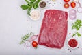 Dry aged Bavette steak with traditional spices and herbs. Fresh raw meat cut, light stone background Royalty Free Stock Photo