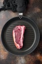 Dry-Aged ÃÂ¡lub raw steak prepared for cooking, on frying cast iron pan, on old dark rustic background, top view flat lay