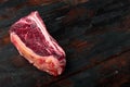 Dry-Aged ÃÂ¡lub raw steak prepared for cooking, on old dark wooden table background, with copy space for text