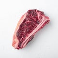 Dry-Aged ÃÂ¡lub raw steak prepared for cooking, square format, on white stone surface