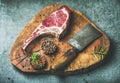 Dry aged raw beef rib eye steak with butcher knife