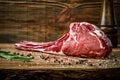 Dry aged raw tomahawk beef steak with ingredients for grilling Royalty Free Stock Photo