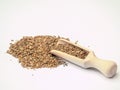 Dry anise seeds in wooden ladle on the white background. Close-up