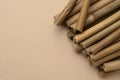 Dry bamboo sticks on beige background, flat lay. Space for text Royalty Free Stock Photo