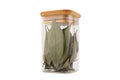 Dry bay leaf in glass jar isolated on a white background. Green bay leaf. Aroma ingredient. Natural healthy food and diet Royalty Free Stock Photo