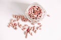 Dry beans in a glass jar on a white table background. Top view. Copy, empty space for text Royalty Free Stock Photo