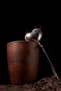 dry black chinese tea set,with strainer closeup,cups and teapot on background over old wood board