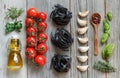 Dry Black Tagliatelle pasta with cherry tomatoes, garlic and her Royalty Free Stock Photo