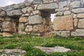 Dry blades of grass against the background of blurry ancient ruins