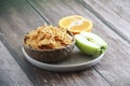 Dry Breakfast muesli on a plate and fruit Apple and orange Royalty Free Stock Photo