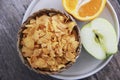 Dry Breakfast muesli on a plate and fruit Apple and orange Royalty Free Stock Photo