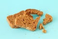 Dry broken bread on a blue background. Royalty Free Stock Photo