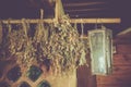 Dry brooms hang in the bath. Dried herbs on very wooden background of ancient kitchen, pharmacy