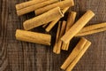 Dry brown cinnamon stick on brown wood Royalty Free Stock Photo