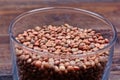 Dry brown lentils in a transparent bowl on table Royalty Free Stock Photo