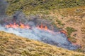 Winchester, CA USA - June 14, 2020: Cal Fire aircraft drops fire retardant on a dry hilltop wildfire near Winchester, California Royalty Free Stock Photo