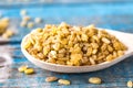 Dry bulgur grain in a wooden spoon. A pile of raw grain Bulgur porridge. Healthy, dietary, vegan, gluten free product. Healthy Royalty Free Stock Photo