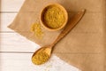 Dry bulgur wheat in wood bowl with spoon on the table