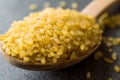 Dry Bulgur Wheat in Wooden Spoon / Bulghur Royalty Free Stock Photo