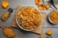 Dry calendula flowers and bottle with tincture on table, flat lay Royalty Free Stock Photo