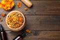 Dry calendula flowers and bottles of essential oil on wooden table, flat lay Royalty Free Stock Photo