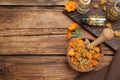 Dry calendula flowers and bottles with tincture on wooden table, flat lay. Space for text Royalty Free Stock Photo