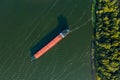 Dry cargo ship with a bird`s eye view on the background of the green color of the river Royalty Free Stock Photo