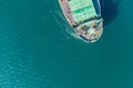 The dry cargo vessel enters the port with the help of tugs. Photo from a helicopter. Bird's-eye view.