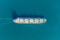 The dry cargo vessel enters the port with the help of tugs. Photo from a helicopter. Bird's-eye view