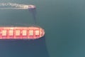 The dry cargo vessel enters the port with the help of tugs. Photo from a helicopter. Bird's-eye view