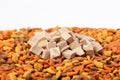 dry cat dog food in granules. Pile heap of pet treats, dried chicken liver on white background Royalty Free Stock Photo