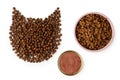 Dry cat food laid out in the shape of a cat's head on white background Royalty Free Stock Photo