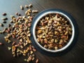 Dry cat food in a stainless steel bowl on wood table. Royalty Free Stock Photo