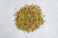 Dry chamomile flowers tea on bright background, herbal plants Royalty Free Stock Photo
